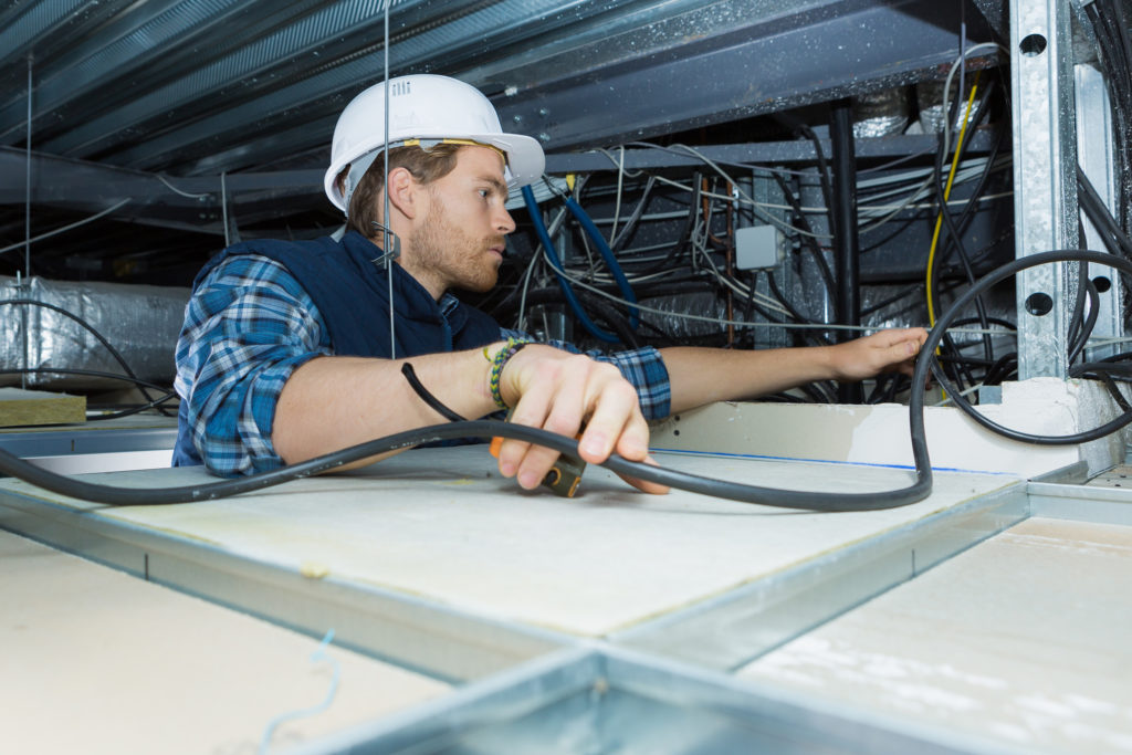 electrician fitting a cable